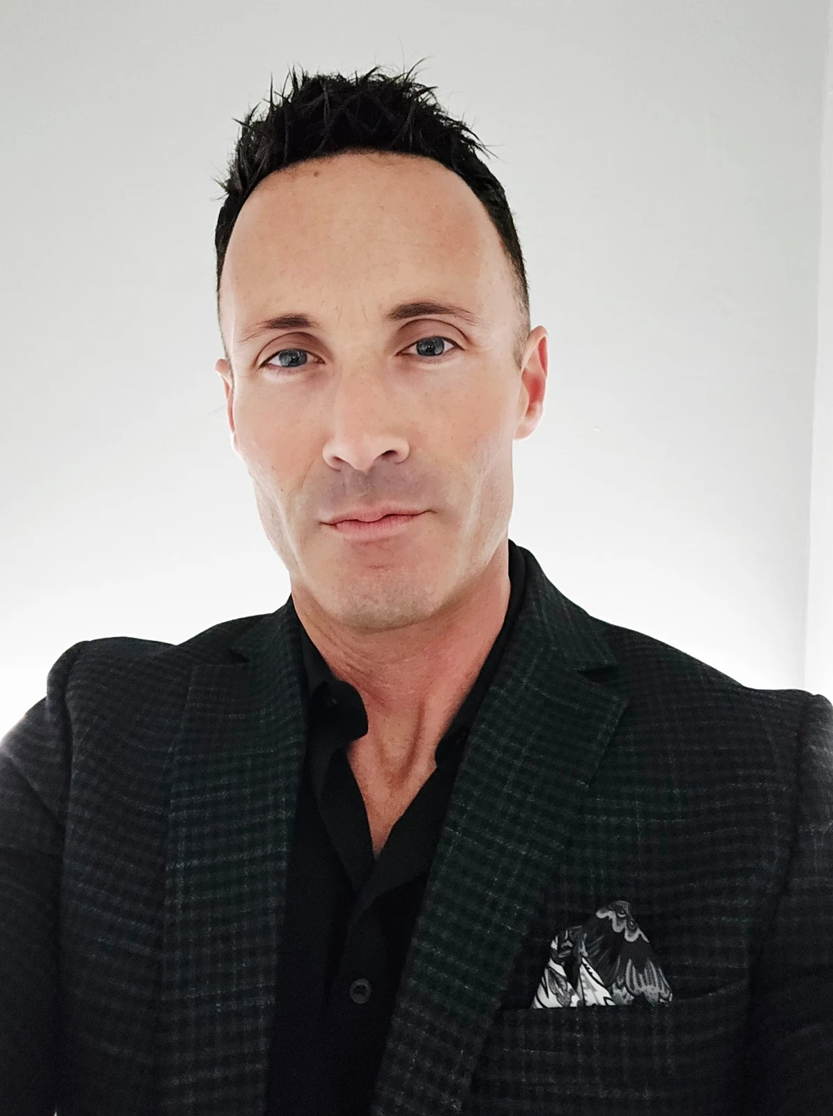 Portrait of Malcolm Kingley in a dark suit jacket
